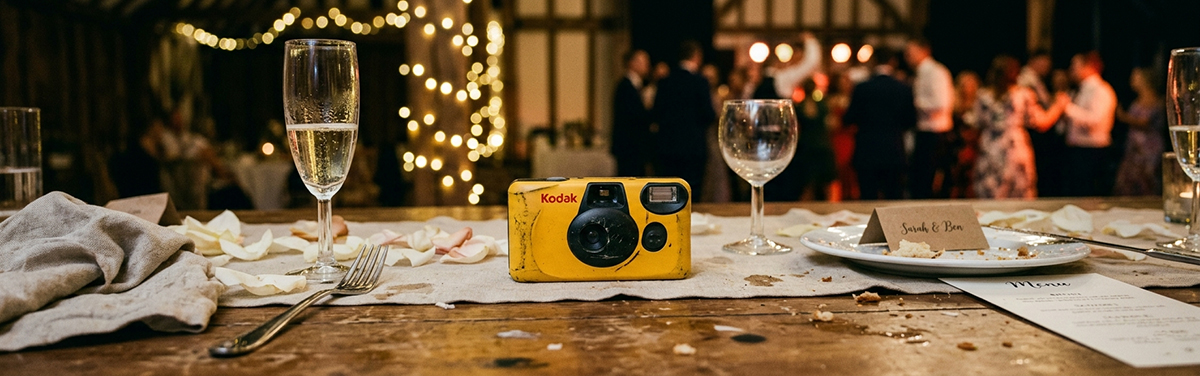 A disposable camera on a table at a wedding reception