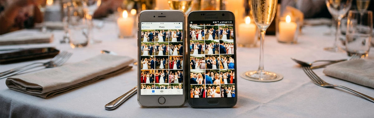 Two phones sit on a table showing photo galleries on each