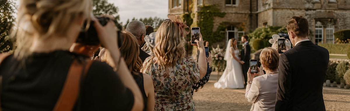 Guests and a photographer taking photos at at wedding